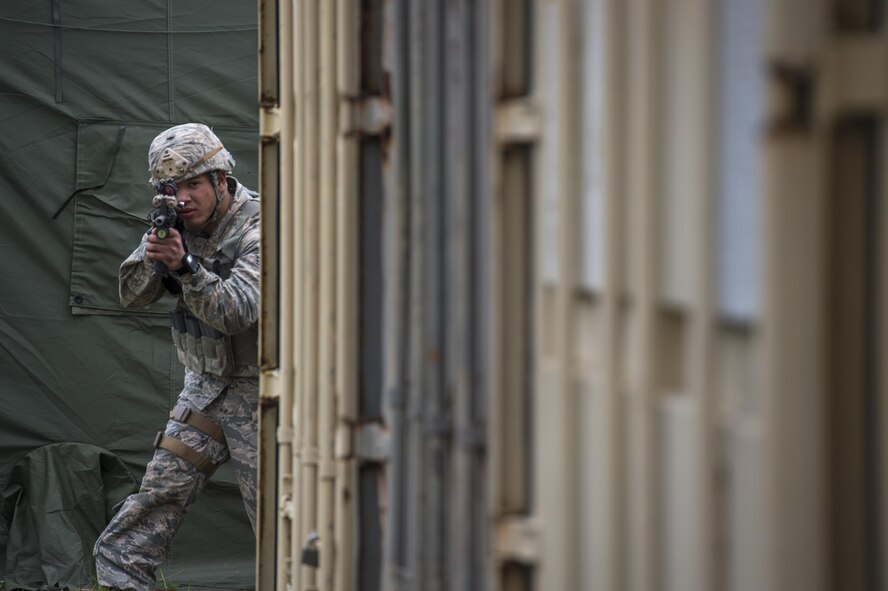 A U.S. Air Force Airman from the 105th Security Forces Squadron rounds a corner during Spartan Warrior week, April 13, 2016, at Avon Park Air Force Range, Fla. Spartan Warrior is an annual combat readiness exercise hosted by the 93d AGOW which brings together battlefield Airmen from 20 geographically separated units (U.S. Air Force photo by Senior Airman Ryan Callaghan/Released)
