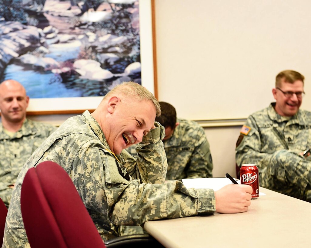 Soldiers from the 85th Support Command share in a laugh during Col. Joel Severson's, Command Chaplain, remarks. Severson shared a few jokes to lighten the atmosphere before conducting a brief on suicide prevention training.
(Photo by Sgt. Aaron Berogan)