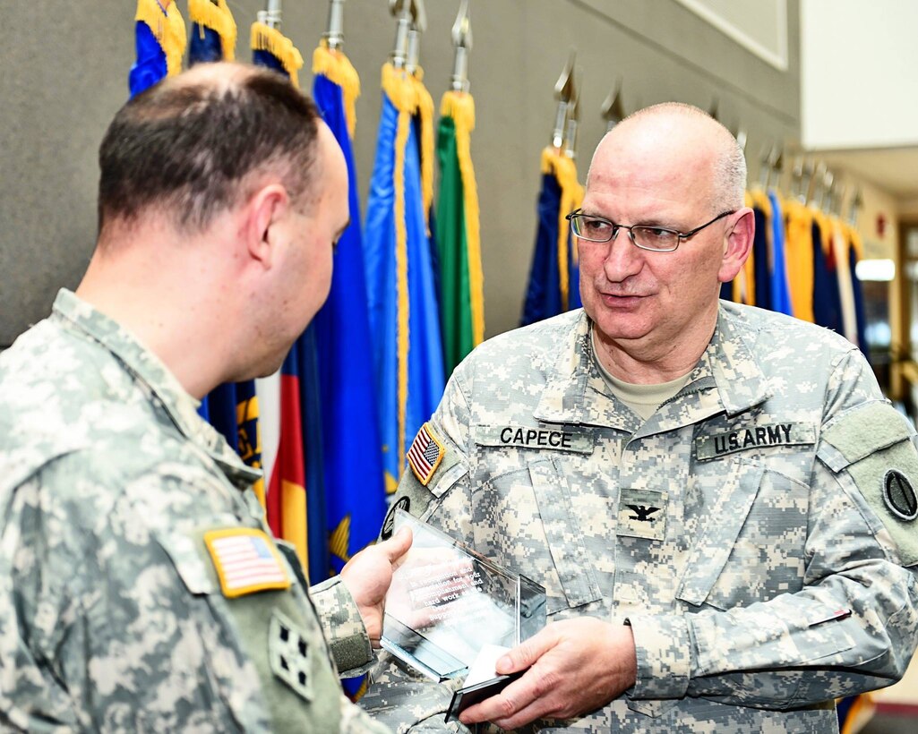 Lt. Col. James Walton, G-8, Financial Management Officer, left, receives a plaque of appreciation from Col. Robert Capece, Assistant Chief of Staff, G-8, right, and the G-8 staff. April's battle assembly was Walton's last with the 85th Support Command. 
We wish him well on his continued journey.
(Photo by Sgt. Aaron Berogan)