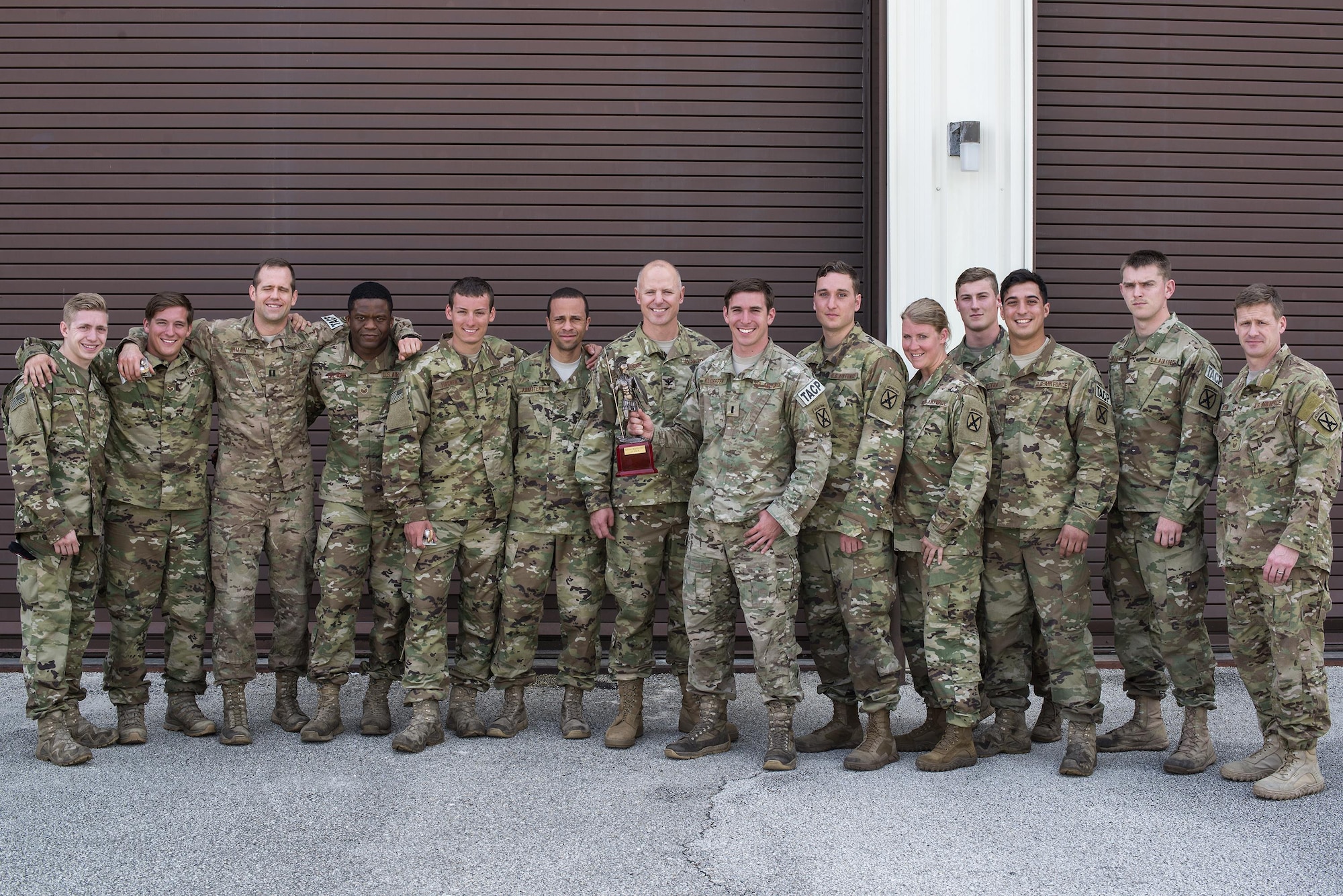U.S. Air Force Col. Joseph Locke 93d Air Ground Operations Wing commander, poses for a photo with Airmen assigned to the 20th Air Support Operations Squadron, April 15, 2016, at Avon Park, Fla. The 20th ASOS won Spartan Warrior week taking home bragging rights and a trophy. (U.S. Air Force photo by Airman 1st Class Janiqua P. Robinson/Released)