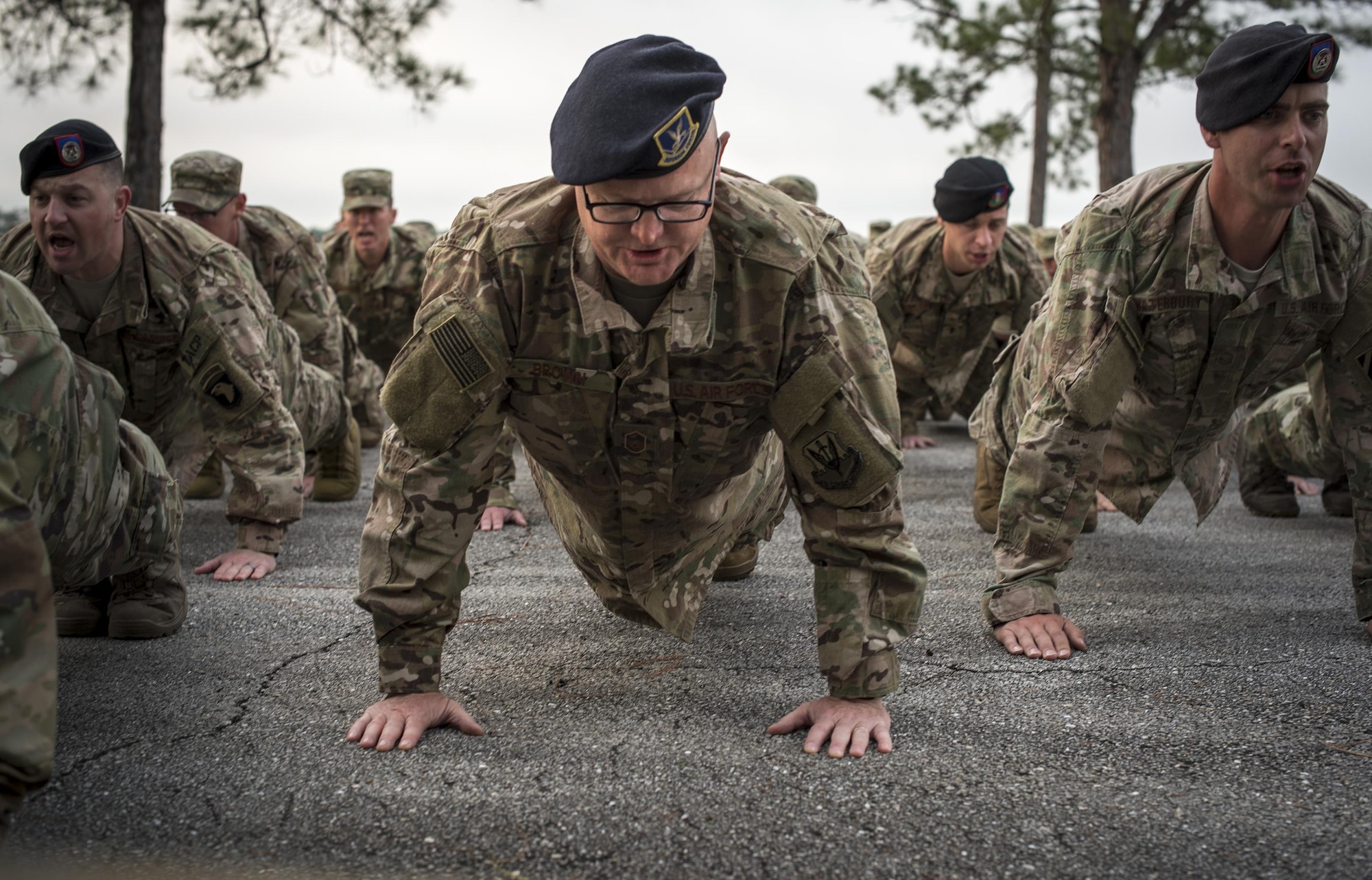 U.S. Air Force Master Sgt. David Brown, 820th Base Defense Group jumpmaster, performs pushups as a tribute to fallen Terminal Air Control Party Airmen, April 15, 2016, at Avon Park Air Force Range, Fla. The Airmen gathered to pay tribute to Lt. Col William Schroeder, who served alongside many members of the 93d AGOW. (U.S. Air Force Photo by Airman 1st Class Janiqua Robinson/Released)
