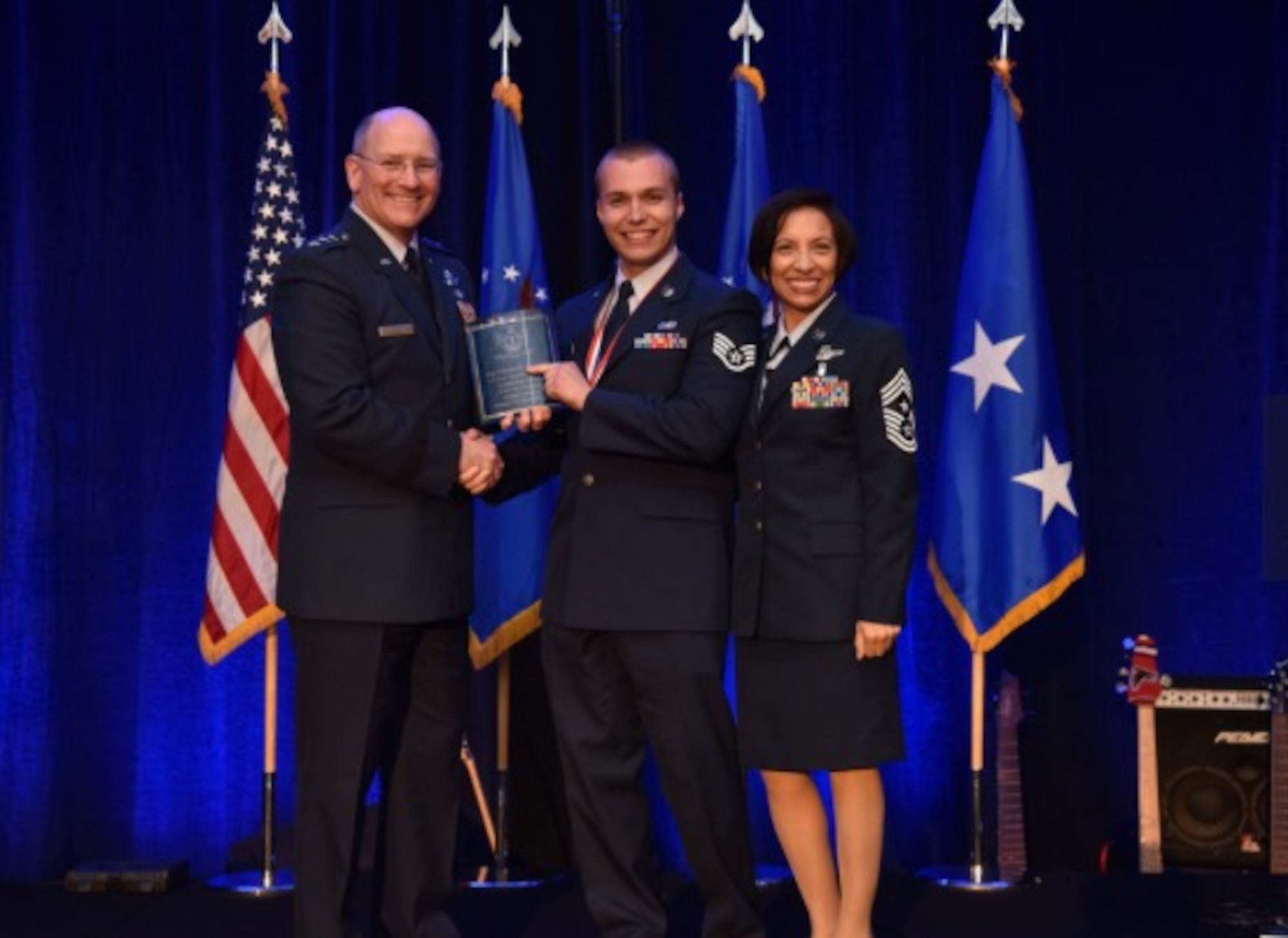 Staff Sgt. Mitchell Ciccarelli, Air Reserve Personnel Center casualty service technician, is presented the 2015 Headquarters Air Force Reserve Command Airman of the Year award by Lt. Gen. James F. Jackson, chief of the Air Force Reserve and commander of AFRC, as Chief Master Sgt. Ericka Kelley, AFRC command chief master sergeant, stands by April 16, 2016, at the AFRC Outstanding Airmen of the Year Banquet held in Jacksonville, Fla. (Air Force courtesy photo)
