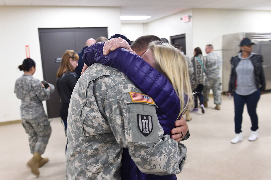 A member of the 814th Military Police Company in Arlington Heights, Ill. embraces their loved one after returning home from Cuba. The 814th MP CO returned from a 10-month deployment at Guantanamo Bay.
(Photo by Spc. David Lietz)