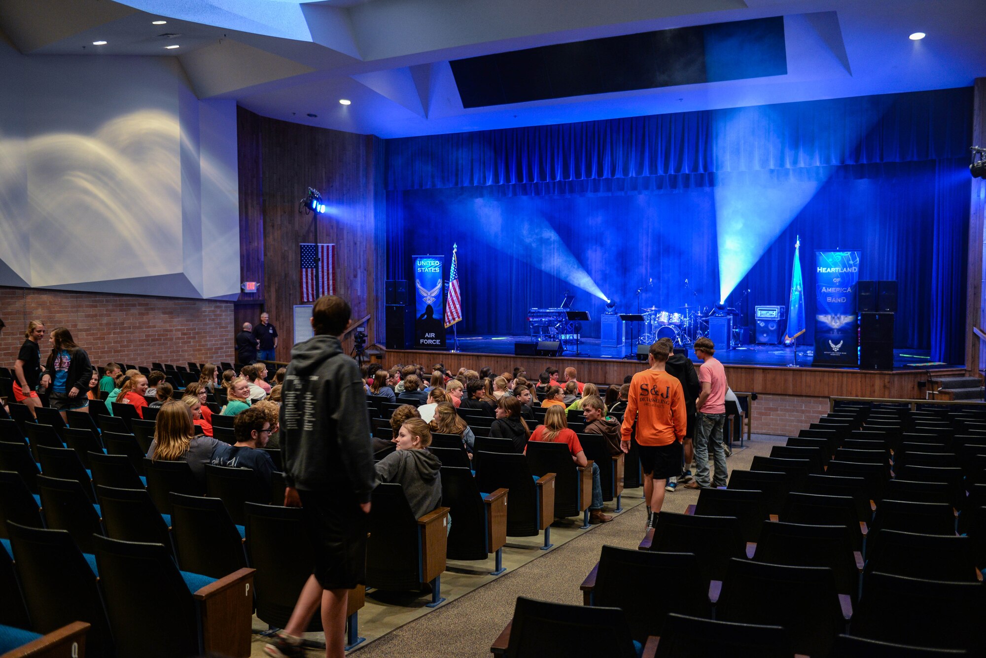 Middle and high school students from Aurora Public Schools assemble in their school auditorium to watch a performance by members of Raptor, an ensemble of the U.S. Air Force Heartland of America Band April 13, 2016, in Aurora, Neb. The Heartland of America Band is a group of Air Force professional musicians whose backgrounds include advanced degrees in music performance and whose broad mastery of musical styles range from classic to contemporary, jazz to country and pop to rock. (U.S. Air Force photo by Zachary Hada)