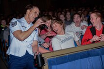 U.S. Air Force Tech. Sgt. Rebecca Packard, a vocalist with the U.S. Air Force Heartland of America Band, sings with students during a concert at Aurora Public Schools on April 13, 2016, in Aurora, Neb. The Heartland of America Band showcases the Air Force’s excellence and precision in every performance. (U.S. Air Force photo by Zachary Hada)