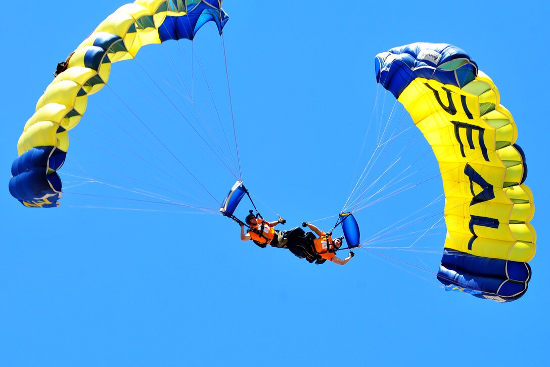 Navy Petty Officers 1st Class T.J. Amdahl and Brandon Peterson, both members of the Navy’s parachute demonstration team, the Leap Frogs, perform over Neyland Stadium during Navy Week in Knoxville, Tenn., April 16, 2016. Amdahl and Peterson are both special warfare operators. Navy photo by Petty Officer 1st Class Bobby Northnagle