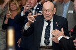 Retired Lt. Col. Dick Cole, co-pilot of Aircraft No. 1 of the Doolittle Tokyo Raid, raises a glass to toast the 74th anniversary of the Doolittle Raid April 18 at Joint Base San Antonio-Randolph. On the same day in 1942, Lt. Col. James H. "Jimmy" Doolittle led a select team of 80 pilots, gunners, navigators and bombardiers to execute a surprise attack over the islands of Japan in retaliation after the sneak attack at Pearl Harbor Dec. 7, 1941.  Cole, at 100-years-old, is one of two remaining survivors of the Doolittle Raid.  Staff Sgt. David Thatcher, who was unable to attend, is the second survivor.