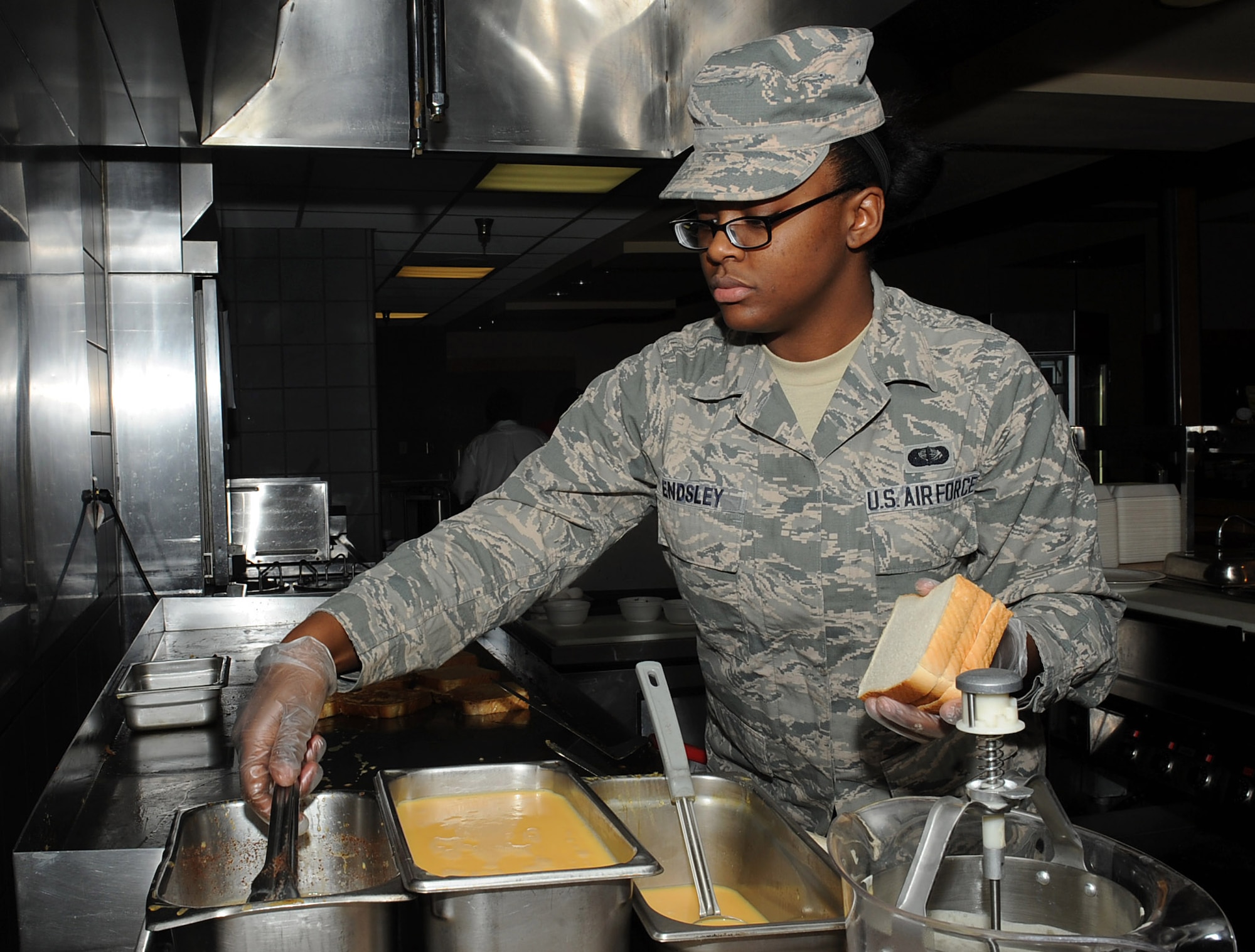 Senior Airman Kelsea Endsley, 22nd Force Support Squadron food services journeyman, prepares breakfast at the Chisholm Trail Inn, April 14, 2016. Endsley recently became a shift leader in the dining facility and now leads breakfast and lunch operations to help keep Airmen fit to fight. (U.S. Air Force photo/Airman Erin McClellan)