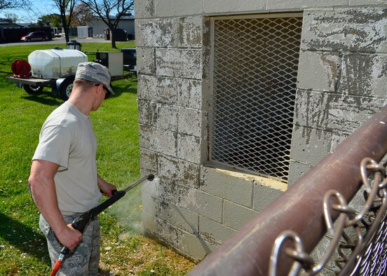 Senior Airman Brock Morris, 436th Civil Engineer Squadron structures, power washes a dugout during a spring cleanup event April 18, 2016, at Dover Air Force Base, Del. More than 40 Airmen from across the base helped to collect trash and pick weeds while the 436th CES completed minor beautification projects. (U.S. Air Force photo/Senior Airman William Johnson) 