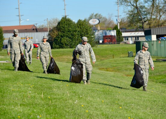 Airmen pick up trash across Dover Air Force Base during a spring cleanup event April 18, 2016, at Dover AFB, Del. More than 40 Airmen from across the base collected trash, picked weeds, and cleaned up common areas. (U.S. Air Force photo/Senior Airman William Johnson)