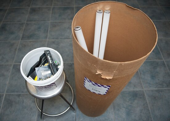 Displayed is a battery Universal Waste container and a light bulb Universal Waste container April 18, 2016, at Dover Air Force Base, Del. Batteries and light bulbs must be disposed of separately and taken to the Hazardous Waste Storage Facility. (U.S. Air Force photo/Senior Airman Zachary Cacicia)