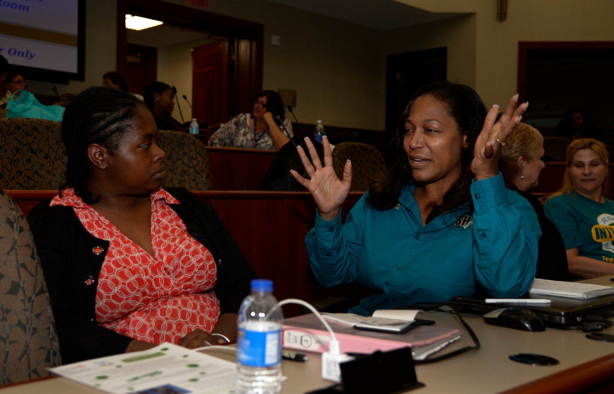 Green Dot training attendees discuss bystander intervention scenarios at MacDill Air Force Base, Fla., April 19, 2016. The Green Dot program focuses on violence prevention and the importance of bystander intervention. (U.S. Air Force photo by Tech. Sgt. Krystie Martinez)