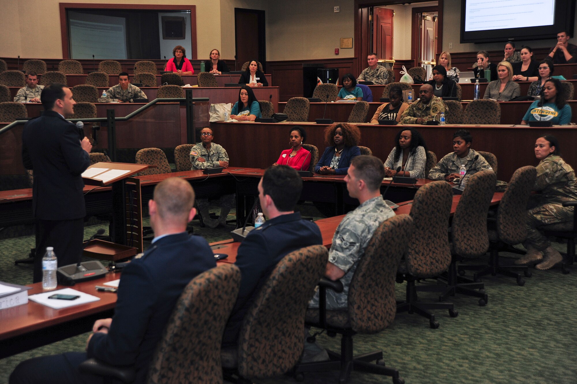 The audience listens as Capt. Kyle Carter, an assistant judge advocate with the 6th Air Mobility Wing, gives the prosecutor opening statement during the first-ever Green Dot mock trial, April 18, 2016, at MacDill Air Force Base, Fla. The goal of this event was to give Airmen a better understanding of the legal process from start to finish, and the opportunity to witness firsthand all the factors that play a role in a sexual assault verdict. (U.S. Air Force photo by Senior Airman Jenay Randolph)