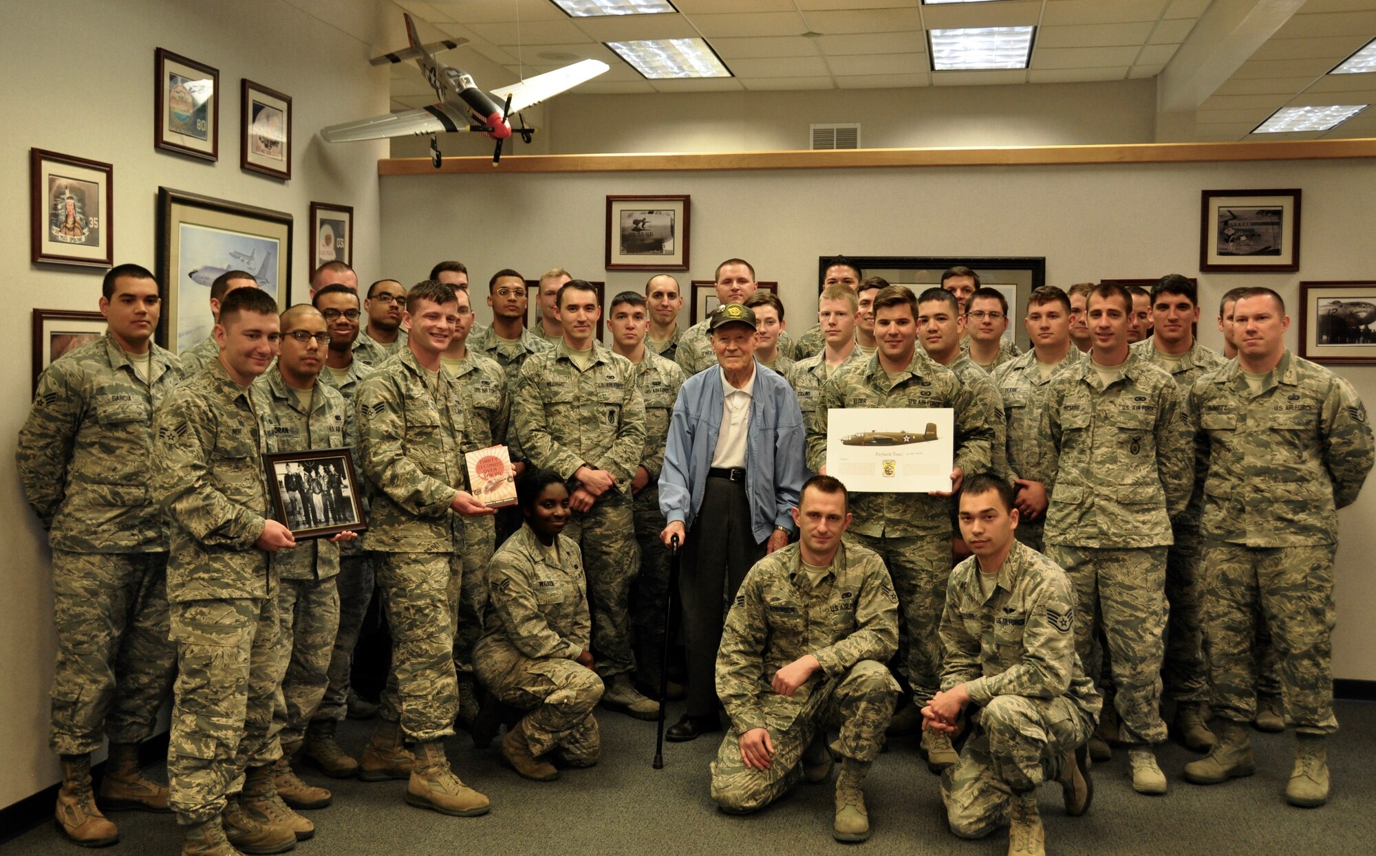 Staff Sgt. David Thatcher gathers with Airman Leadership School students, April 18, 2016, at Fairchild Air Force Base, Wash. Thatcher presented Fairchild ALS with a signed photo of Flight Crew No. 7 of the Doolittle Raid, along with a copy of “30 Seconds Over Tokyo” and a print of a B-25 Mitchell aircraft. (U.S. Air Force photo/2nd Lt. Shelley Gregory)