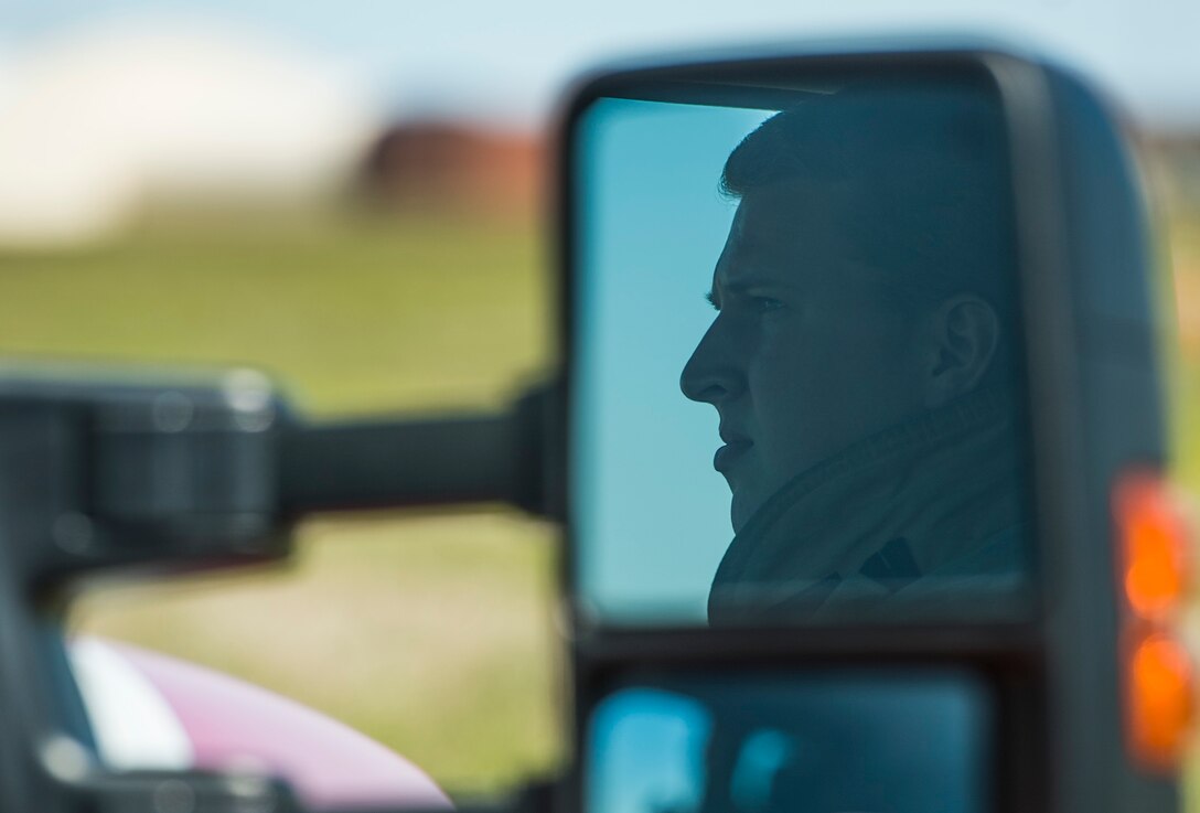 U.S. Air Force Senior Airman Colton Peer, a firefighter assigned to the 633rd Civil Engineer Squadron, observes a controlled burn at Langley Air Force Base, Va., April 17, 2016. The 633rd CES firefighters and the Virginia Department of Forestry performed the controlled burn as a precautionary measure in the event of any mishaps during the fireworks show during the AirPower over Hampton Roads Open House. (U.S. Air Force photo by Senior Airman Kayla Newman)
