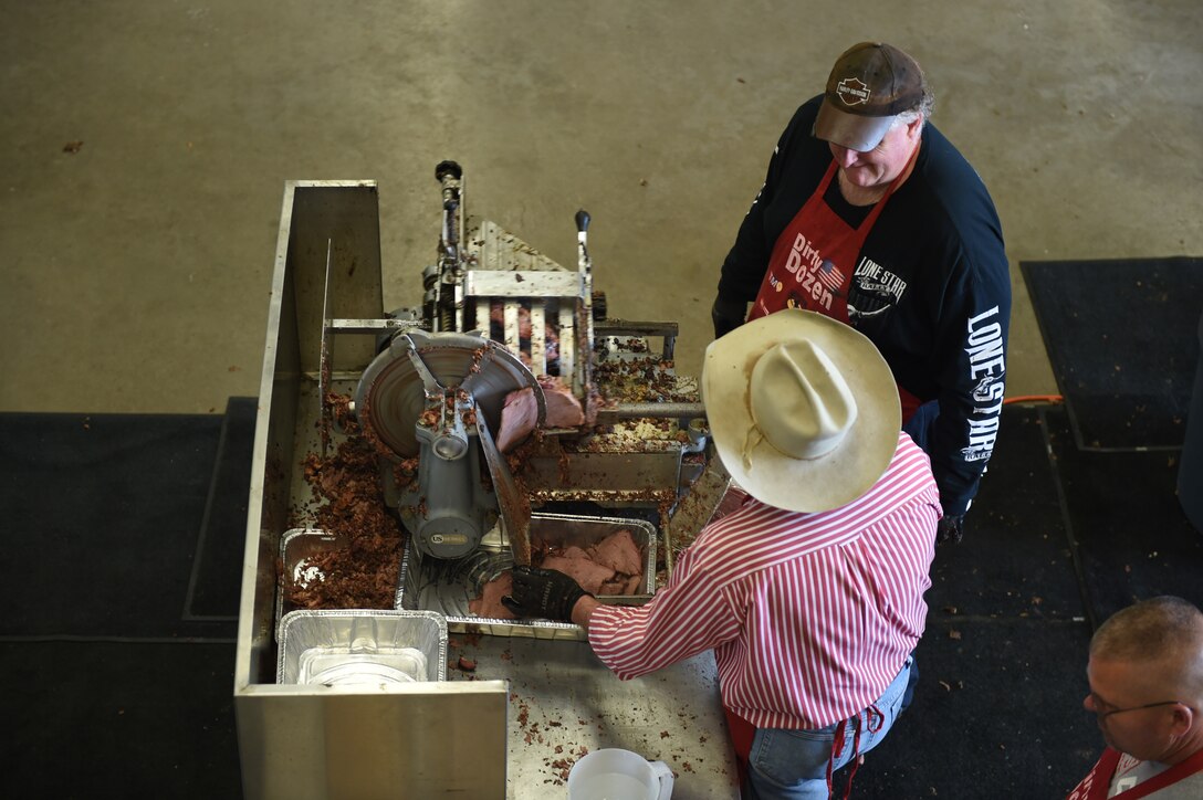 Volunteers slice meat in preparation of the World’s Largest Barbeque April 16, 2016, at the Abilene Civic Center, Abilene, Texas. Volunteers prepared and served an estimated 3,075 pounds of meat to military members and their families at this year’s barbeque. The Abilene Chamber of Commerce Military Affairs Committee gathers food donated by local businesses and volunteers from the community to provide free barbeque to military members and their families. (U.S. Air Force photo by Airman 1st Class Quay Drawdy/Released)