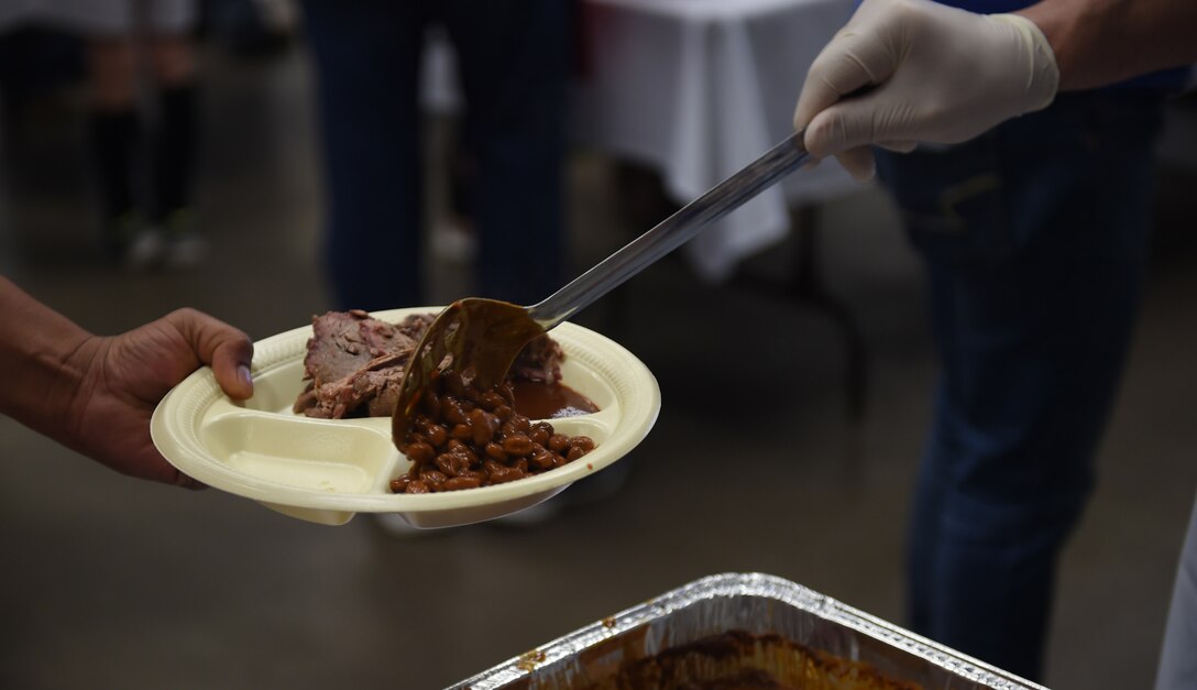 Military members and their families are served free meals at the World’s Largest Barbeque April 16, 2016, at the Abilene Civic Center, Abilene, Texas. The Abilene Chamber of Commerce Military Affairs Committee hosts the event each year to thank military members and their families for the sacrifices they make every day. (U.S. Air Force photo by Airman 1st Class Quay Drawdy/Released)