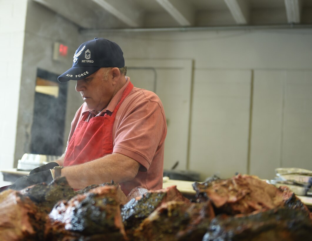 Chief Master Sgt. (Ret.) Robert Pulse, a World’s Largest Barbeque food preparation volunteer, cuts helpings of beef April 16, 2016, at the Abilene Civic Center, Abilene, Texas. The Abilene Chamber of Commerce Military Affairs Committee hosts the World’s Largest Barbeque to thank service members of the local community for their daily sacrifice. The MAC provided 2,750 pounds of beef, 600 pounds of sausage, and over 485 gallons of tea, all of which was either donated by local businesses or purchased by the Abilene Chamber of Commerce. (U.S. Air Force photo by Airman 1st Class Quay Drawdy/Released)