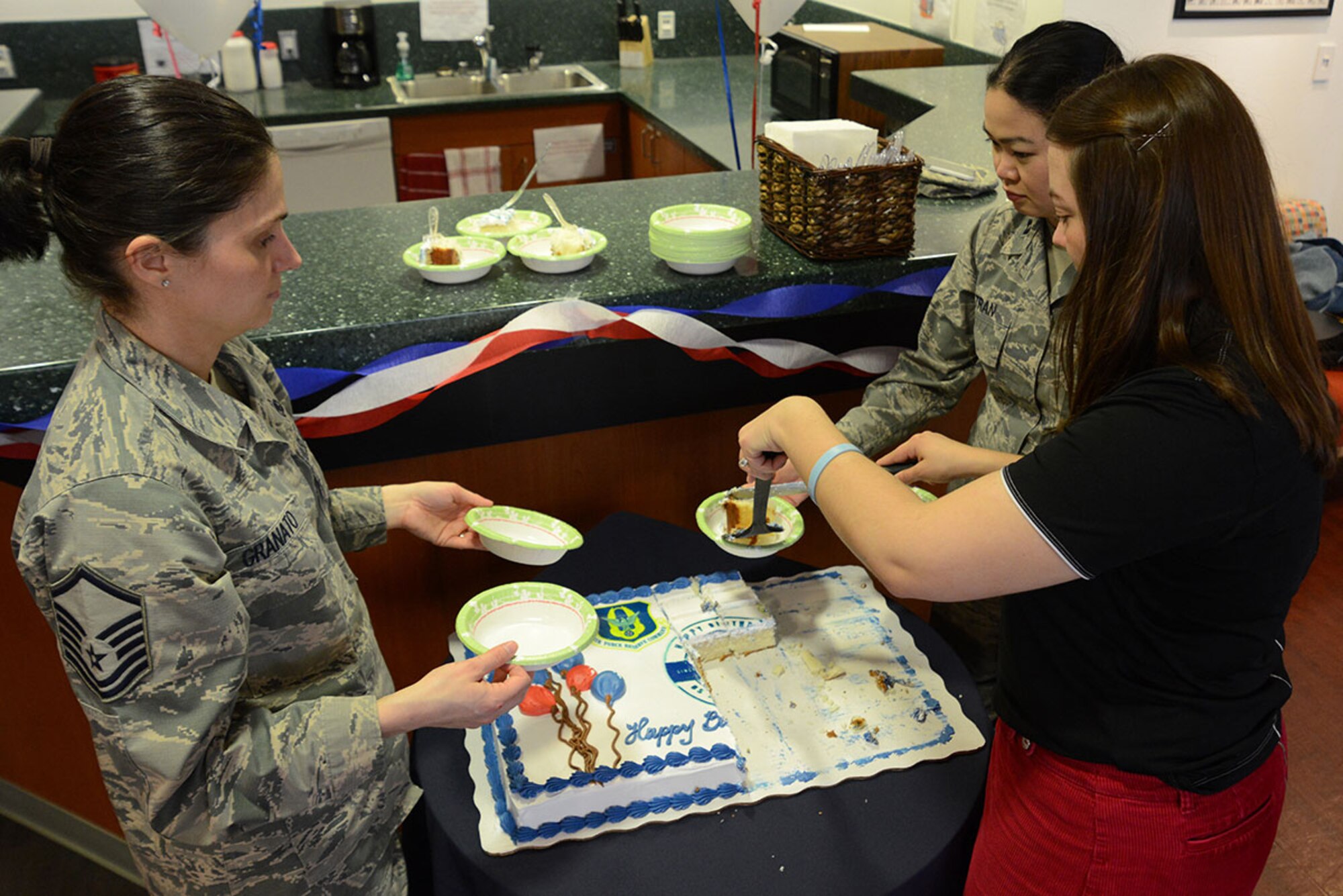 Participants cut slices of cake at the Air Force Reserve 68th birthday celebration at Joint Base Elmendorf-Richardson, Alaska, April 14, 2016. The theme was “Stationed Locally, Serving Globally” in honor of more than 69,000 citizen Airmen stationed in more than 66 communities throughout the United States and overseas. Citizen Airmen serve globally in every combatant command in air, space and cyberspace. (U.S. Air Force photo by Airman 1st Class Christopher R. Morales)