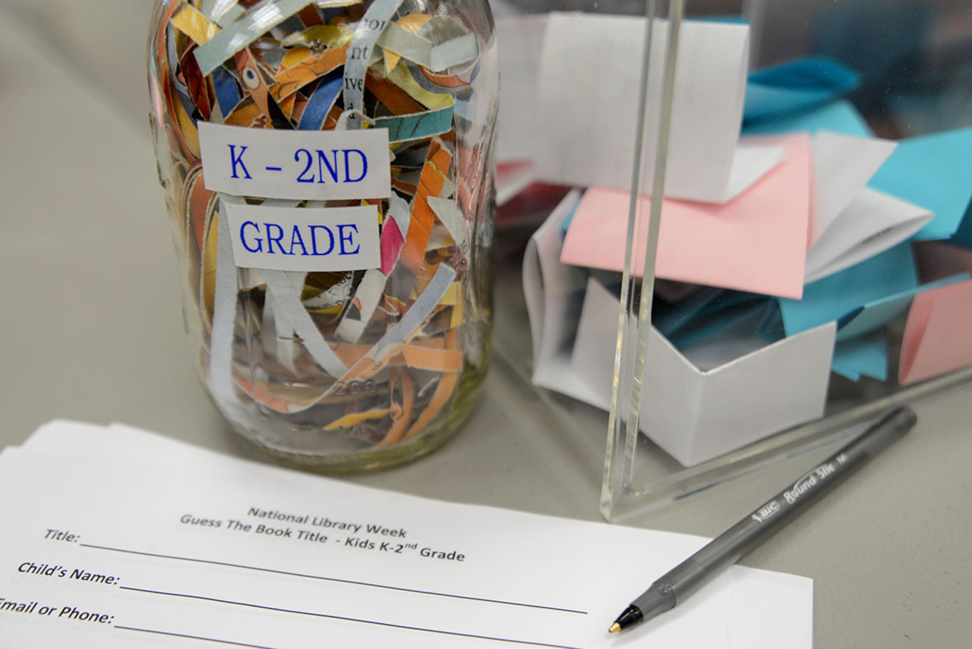 The Joint Base Elmendorf-Richardson Consolidated Library hosts a guessing contest in honor of National Library Week at JBER, Alaska, April 12, 2016. Three books are shredded in a jar, one for each age group; Kindergarten through 2nd grade, 3rd grade through 6th grade, and 7th grade and up. (U.S. Air Force photo by Airman 1st Class Christopher R. Morales)