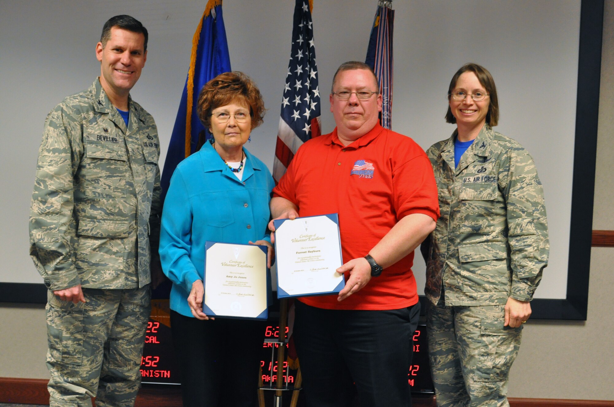 Col. John Devillier, 88th Air Base Wing commander, left, and Col. Elena Oberg, 88th Air Base Wing vice commander, right, recognize Amy Jo Jones and Forrest Rayburn as recipients of the Wright-Patterson Air Force Base Volunteer Excellence Award April 15 at the annual volunteer recognition ceremony. (U.S. Air Force photo/Jim Mitchell) 