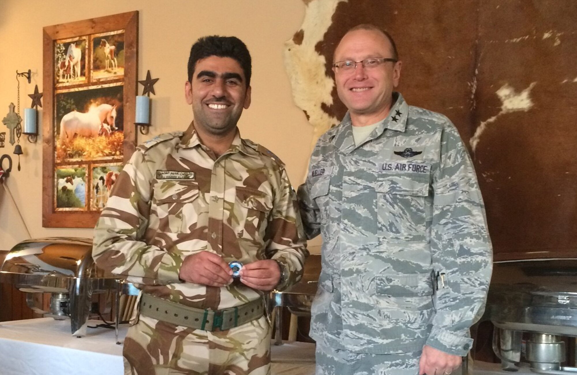 1st Lt. Ali Khadeem Said Al-Fathi, Royal Air Force of Oman, displays the commander's coin presented by Maj. Gen. Andrew M. Mueller, Air Force chief of safety, as the 1,000th student to attend the Air Force Safety Center's International Flight Safety Officer Course at Kirtland Air Force Base, N.M., on April 12. The IFSO course provides safety education for international officers who manage flight safety programs and an understanding of safety program management fundamentals, safety principles and mishap investigation techniques. (Courtesy photo by Gwendolyn F. Dooley)
