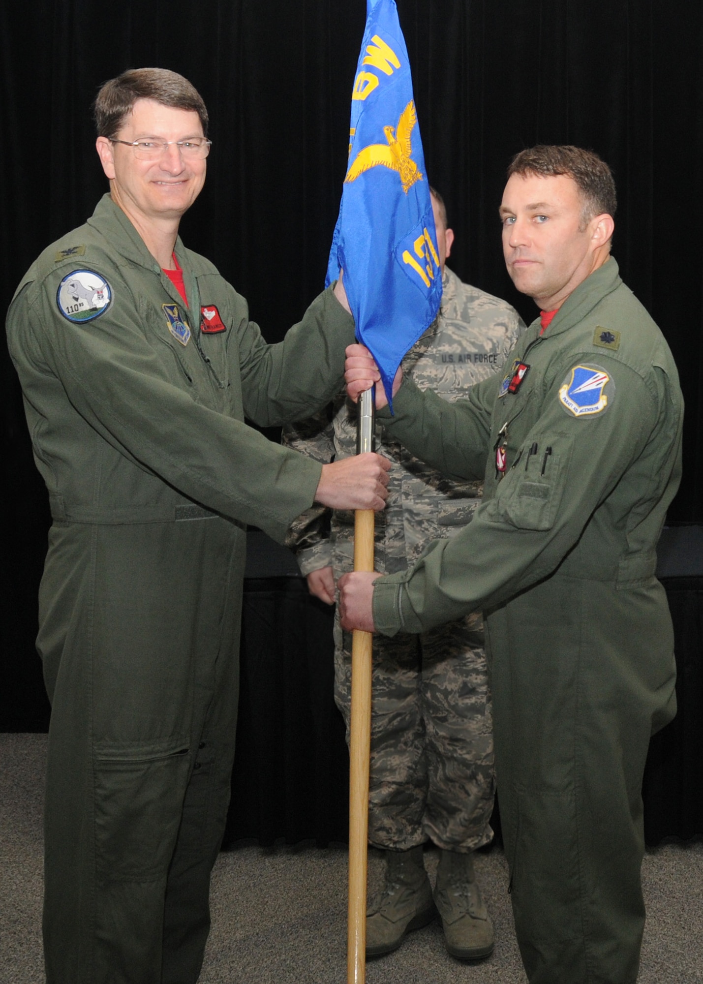 Lt. Col. Jared Kennish receives the 131st Operations Group guidon from Col. Mike Francis, 131st Bomb Wing commander, during the assumption of command ceremony at Whiteman Air Force Base, Missouri, April 17.   (U.S. Air National Guard photo by Sr. Airman Nathan Dampf)

