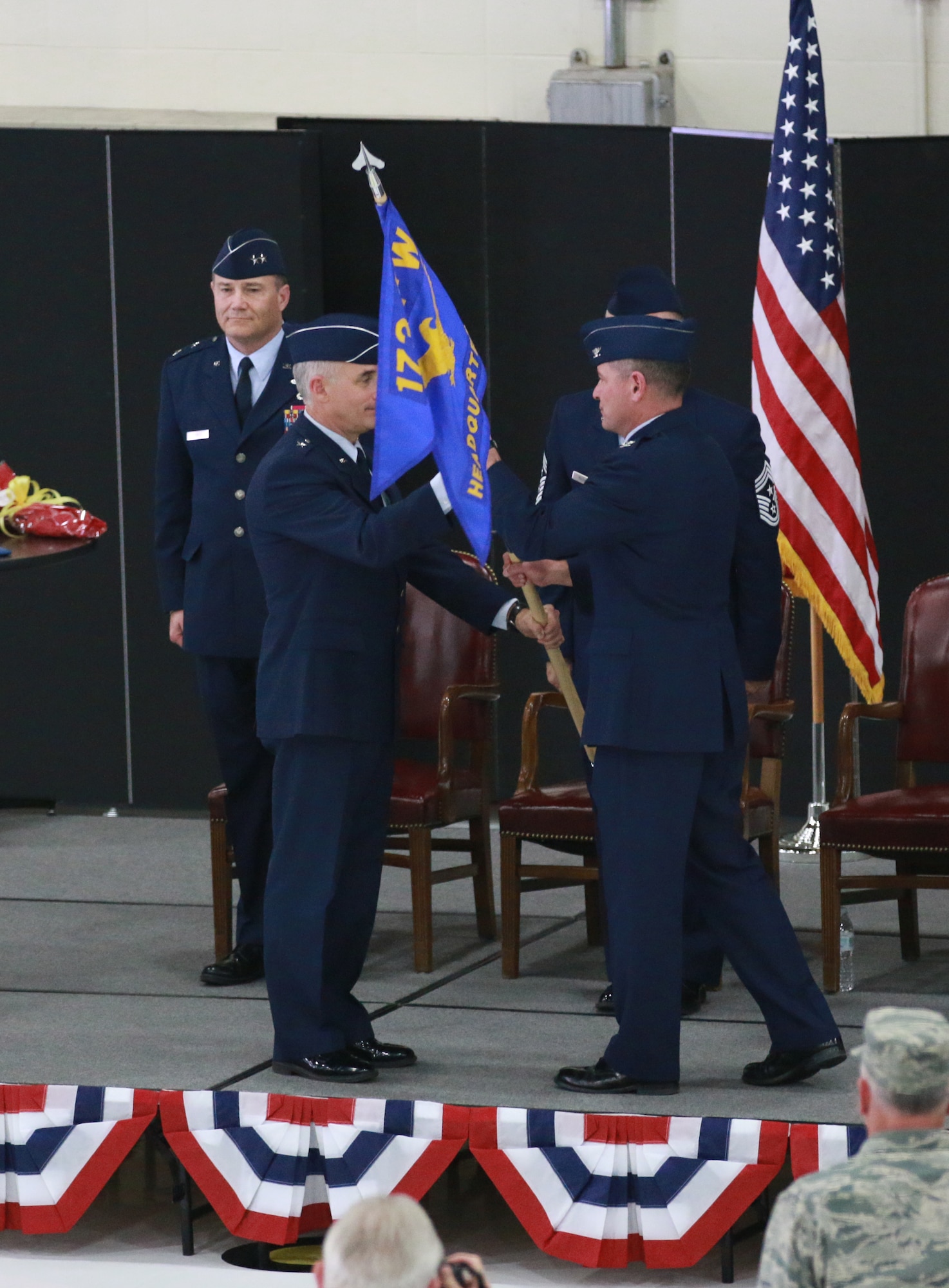 Brig. General Jeff Silver, Oregon Air National Guard Commander, passes the guideon to Col. Jeffrey Smith as he accepts command of the 173rd Fighter Wing during a change of command ceremony April 3, 2016 at Kingsley Field in Klamath Falls, Ore. Brig. Gen. Kirk Pierce relinquished command following his promotion to flag rank earlier in the afternoon. (U.S. Air National Guard photo by Tech. Sgt. Jefferson Thompson/released)