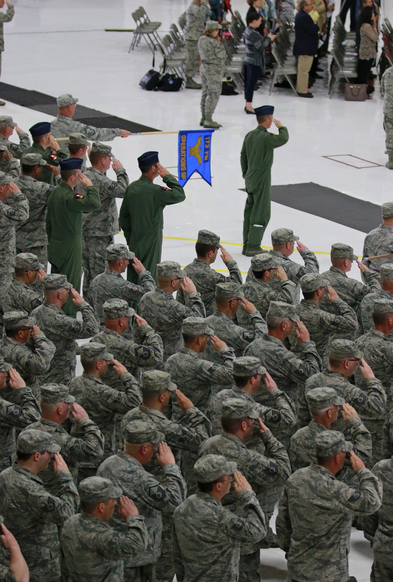 The assembled Airmen of the 173rd Fighter Wing render a salute to the U.S. Flag during a change of command ceremony in which Col. Jeffrey Smith accepted the helm from Brig. Gen. Kirk Pierce April 3, 2016 at Kingsley Field in Klamath Falls, Ore.  Smith, the former maintenance group commander, brings with him a wealth of experience with just over 20 years of service.   (U.S. Air National Guard photo by Tech. Sgt. Jefferson Thompson/released)