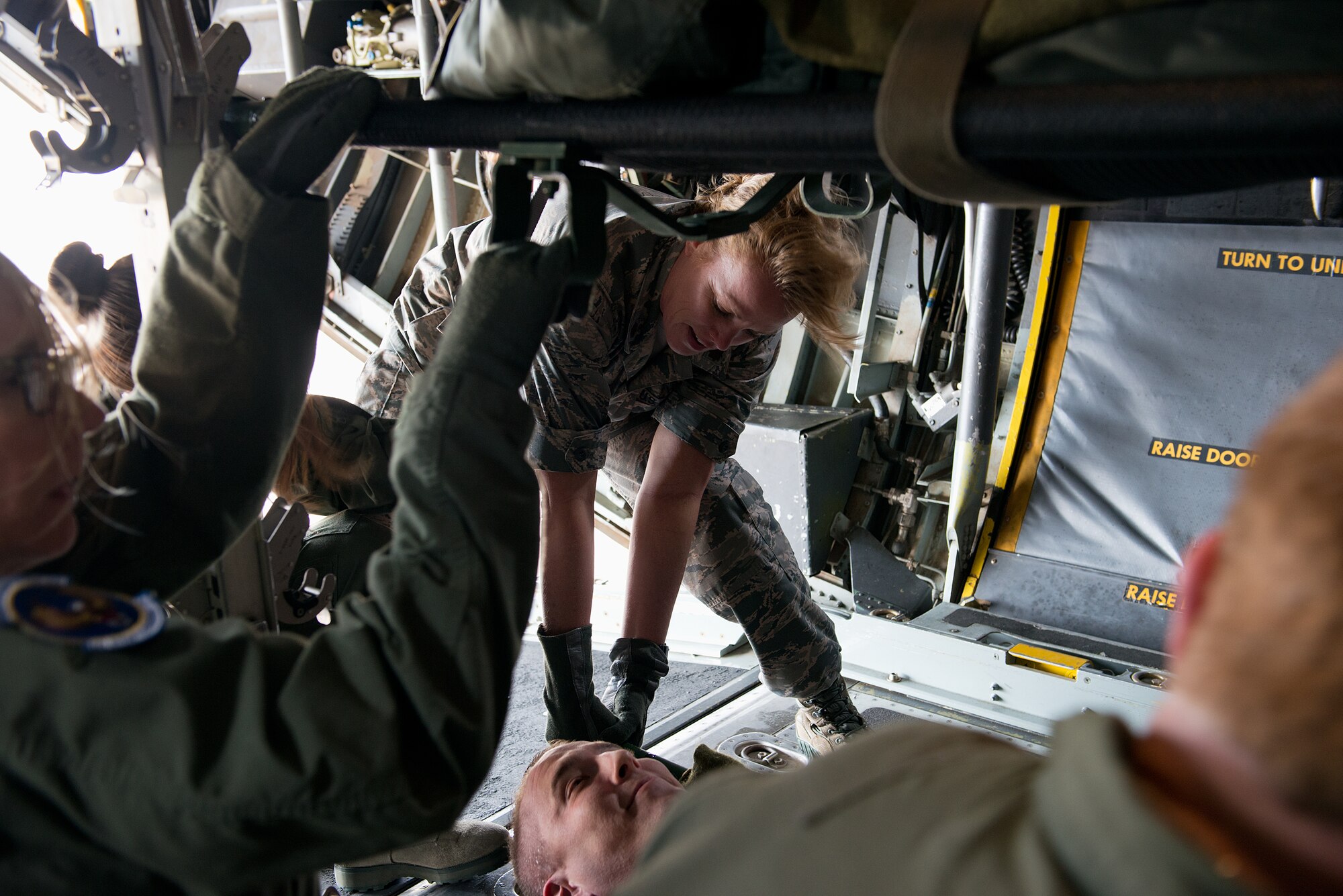 Maj. Ellen Osbourne from the 156th Aeromedical Evacuation Squadron, Charlotte, North Carolina, helps secure simulated patients as part of the Multiple Aircraft Training Opportunity Program training event held at Will Rogers Air National Guard Base, Oklahoma City, April 15-16, 2016. The 137th Aeromedical Evacuation Squadron hosted five other aeromedical squadrons at the two-day event. (U.S. Air National Guard photo by Master Sgt. Andrew LaMoreaux/Released) 
