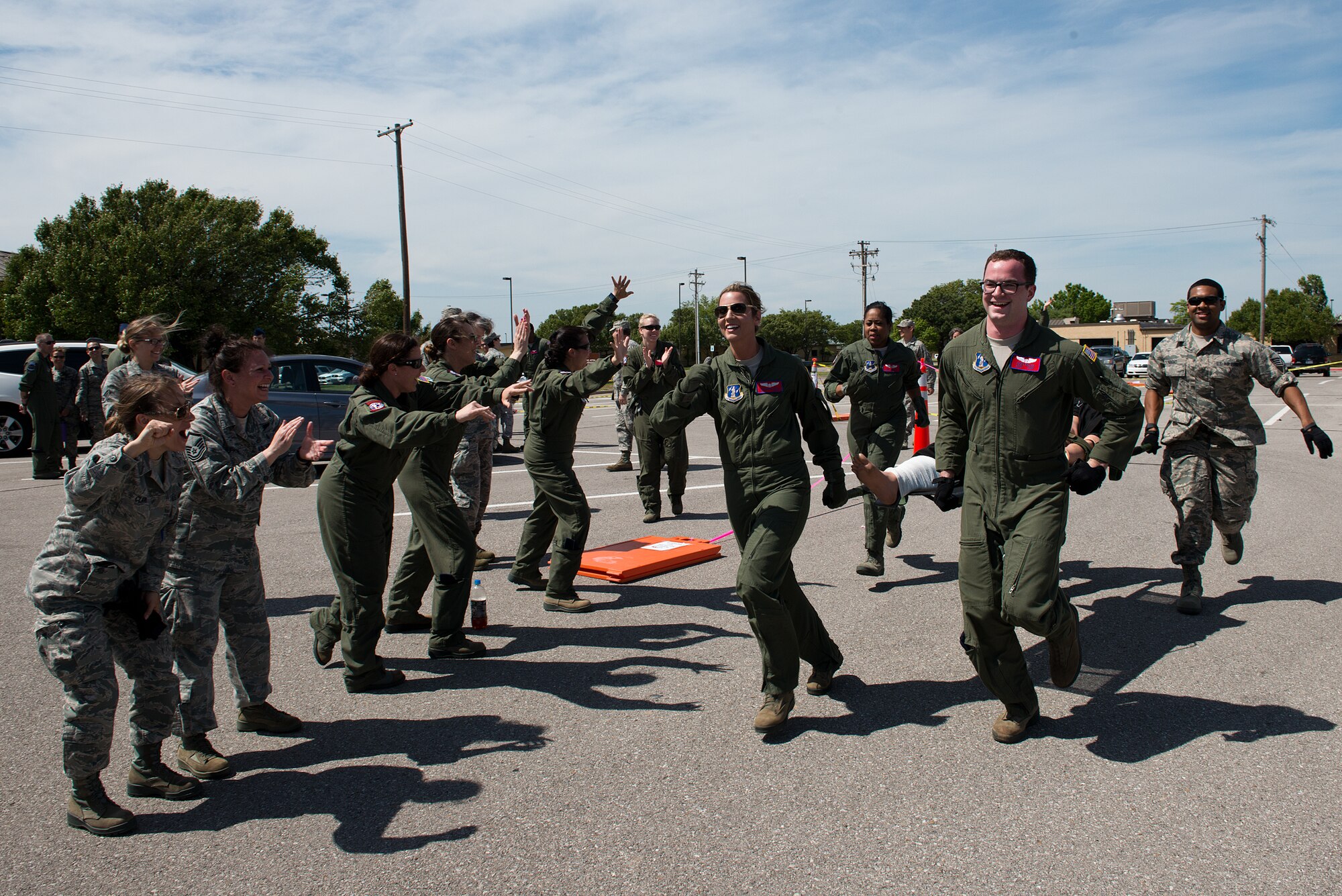 Airmen from the 137th Aeromedical Evacuation Squadron race to the finish line during a custom litter carry obstacle course as part of the Multiple Aircraft Training Opportunity Program training event held at Will Rogers Air National Guard Base, Oklahoma City, April 15-16, 2016. The 137th Aeromedical Evacuation Squadron hosted five other aeromedical squadrons at the two day event. (U.S. Air National Guard photo by Master Sgt. Andrew LaMoreaux/Released)