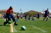 A student knocks down a cone simulating a base during a functional leadership exercise, or FLEX game, on Maxwell Air Force Base, Ala., March 21, 2016. During the five-week SOS course, captains from throughout the Air Force learn how to create and execute strategic war plans during a wartime conflict. (U.S. Air Force photo/Senior Airman Tammie Ramsouer)