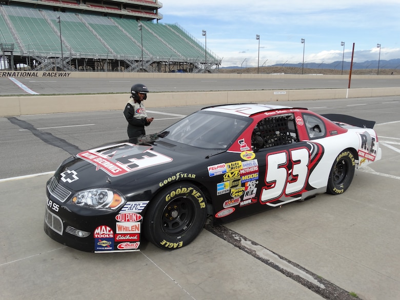 Airman 1st Class Aleesha Regino, 50th Force Support Squadron, prepares to enter a NASCAR race car during the Richard Petty Driving Experience at the Pikes Peak International Raceway in Colorado Springs, Colorado, Friday, April 15, 2016, as a part of the Single Airman Initiative. Regino was one of 10 Schriever single Airmen who rode shotgun in an official NASCAR race car with a professional driver and took three high-speed laps around the track. (Courtesy photo/Seth Cannello)