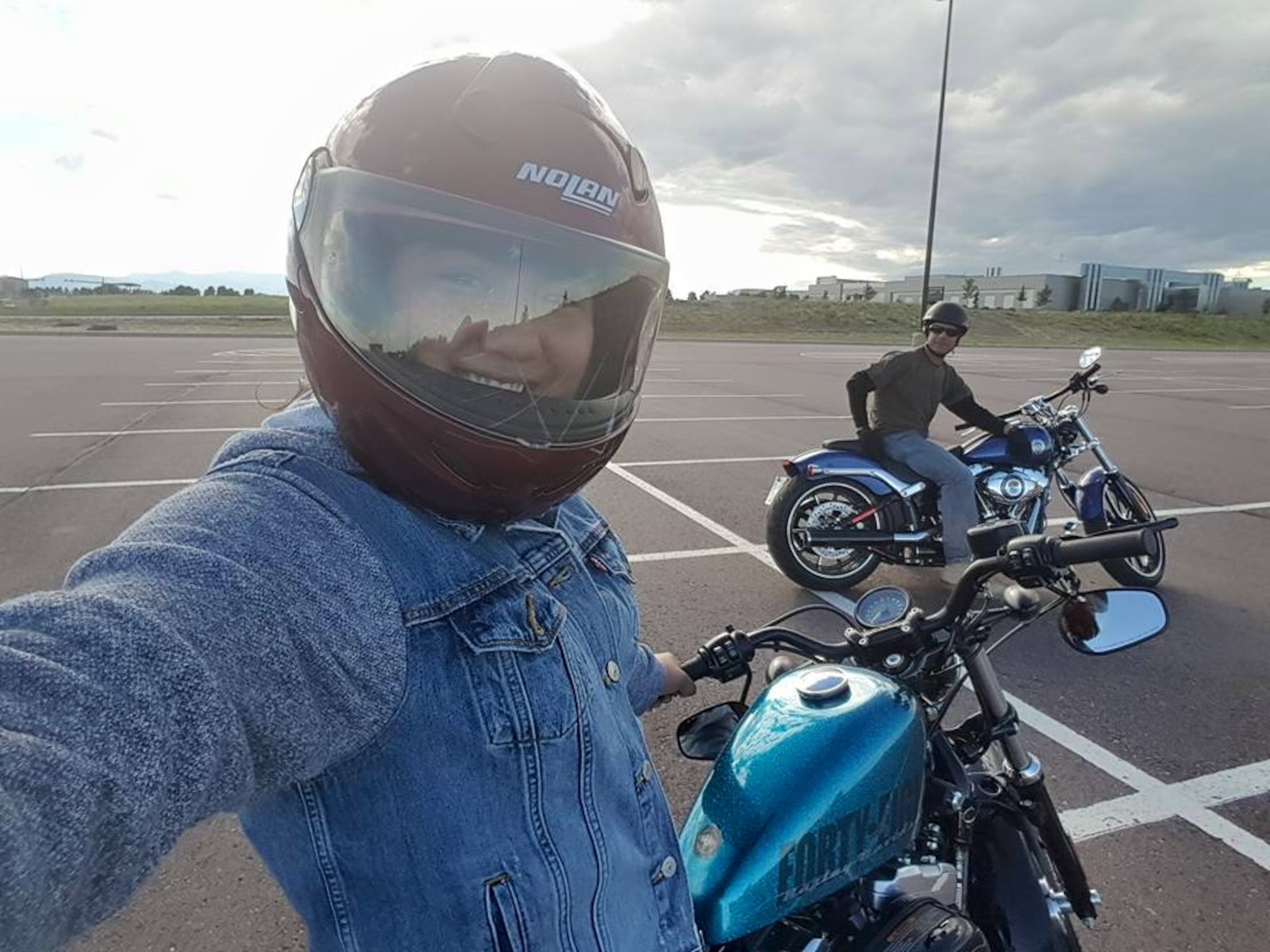 Kaitlyn Bentivegna takes a selfie with her father, Chief Master Sgt. John Bentivegna, 50th Space Wing command chief, during a motorcycle ride at Schriever Air Force Base, Colorado, in August 2015. The chief places a great deal of emphasis on safety and paid for his daughter and wife to complete the motorcycle safety course that is required of all Airmen who ride. (Courtesy photo)