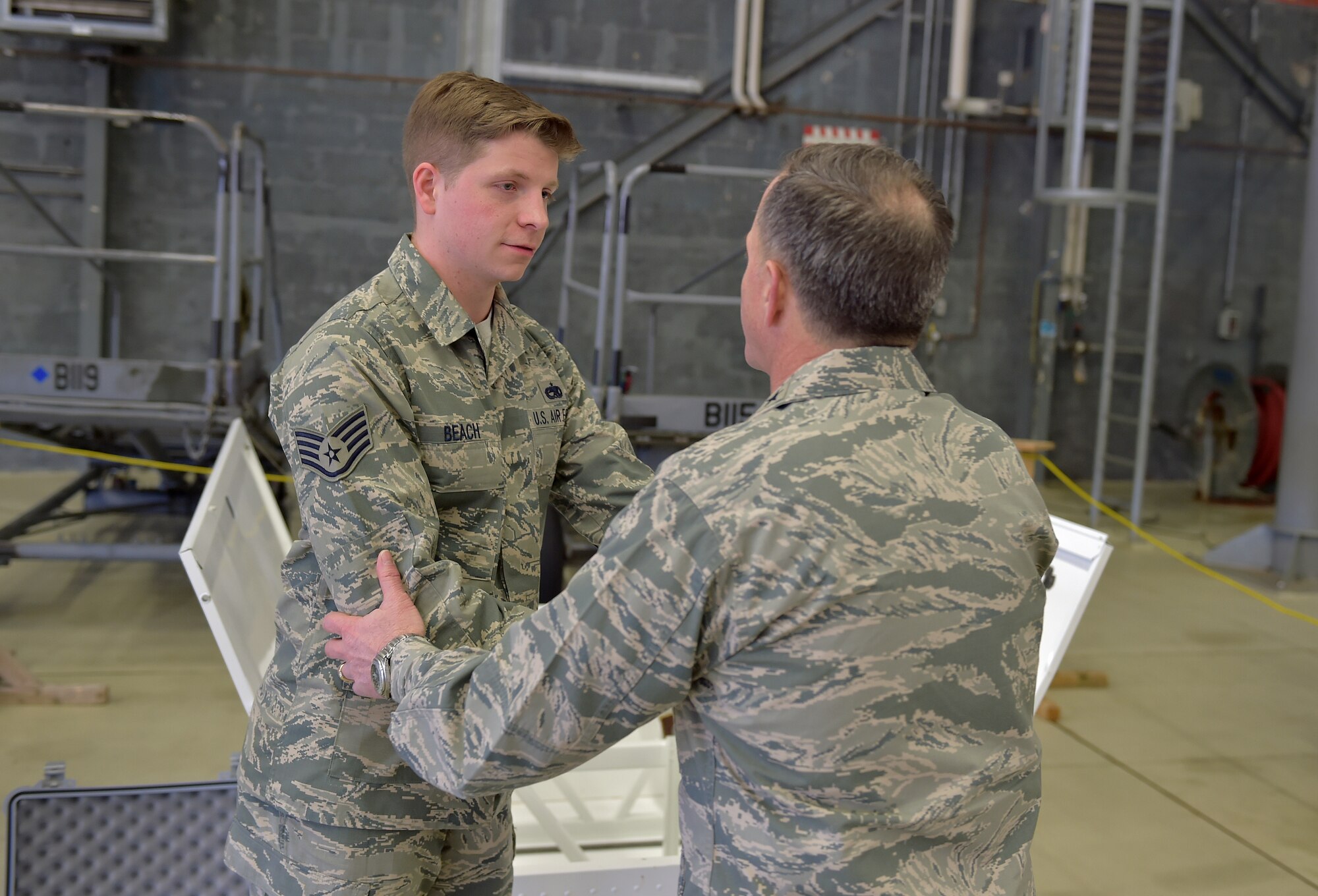 U.S. Air Force Vice Chief of Staff Gen. David L. Goldfein speaks with Staff Sgt. Gregory Beach, 86th Maintenance Squadron member, during his visit to Ramstein Air Base, Germany, 18 April 2016. Beach gave Goldfein a brief on a unique innovation developed and implemented locally where a filing cabinet was converted into fuel tank trainer. The fuel trainer was constructed out of the filing cabinet, expended parts, sheet metal and fasteners; the trainer eliminates exposure to hazardous fuel tanks on operational aircraft and without this innovative tool the unit would need to gain access to a wing section of a C-130J Hercules to ensure personnel remain trained. (U.S. Air Force photo/1st Lt. Clay Lancaster)