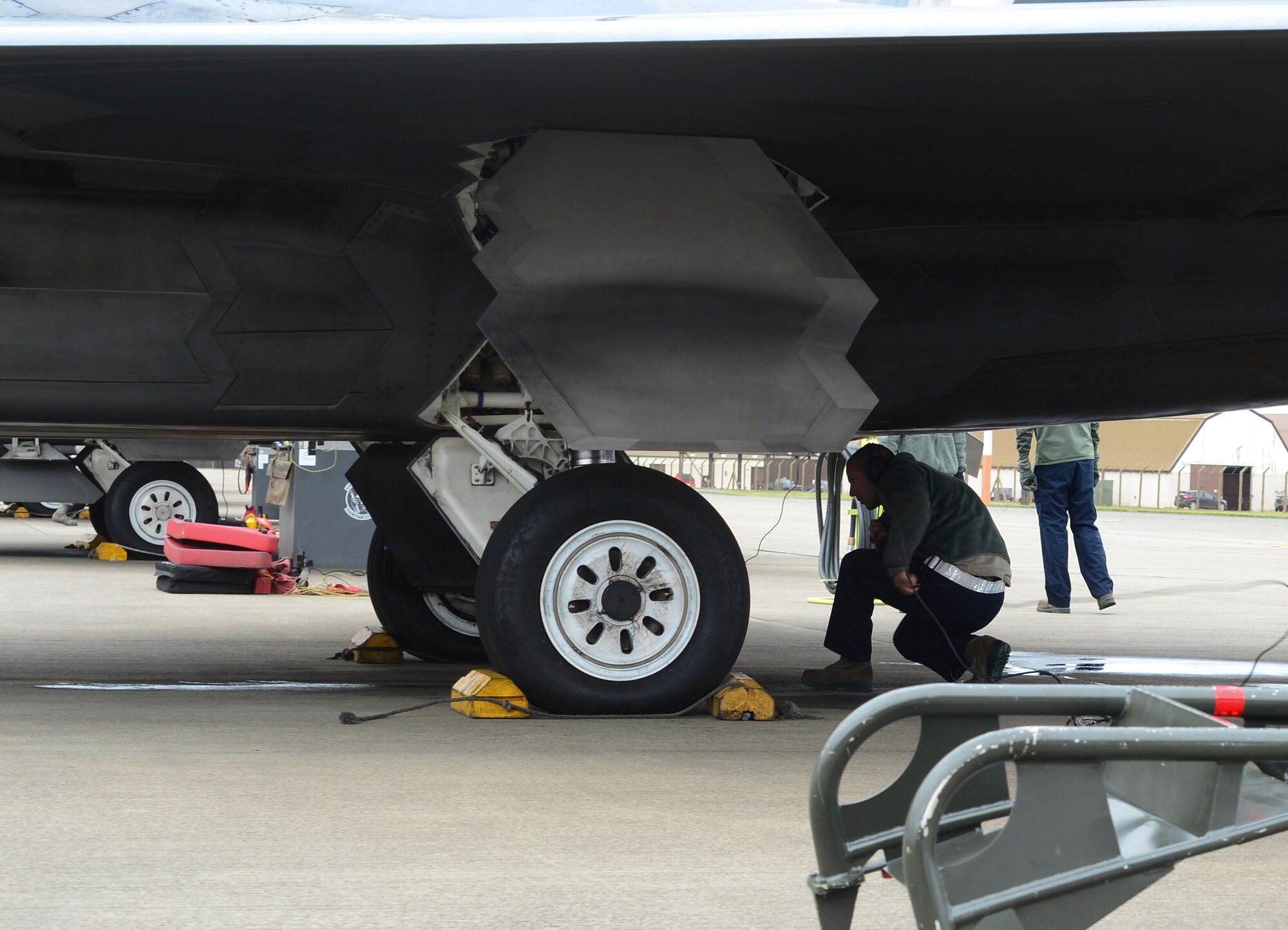 Maintenance Airmen assigned to the 325th Maintenance Squadron, Tyndall Air Force Base, Fla., perform pre-flight checks on an F-22 Raptor at Royal Air Force Lakenheath, England, April 18, 2016. The F-22s deployed from the 95th Fighter Squadron at Tyndall Air Force Base, Fla., and will be conducting air training exercises with other U.S. and Royal Air Force aircraft. (U.S. Air Force photo by Senior Airman Dawn M. Weber/Released)