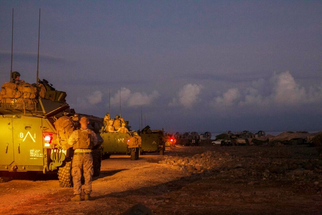 U.S. Marines and sailors with the 13th Marine Expeditionary Unit prepare to depart on an early morning convoy to a live firing range in Djibouti, Africa, Apr. 17, 2016. The 13th MEU is conducting sustainment training to maintain proficiency and combat readiness as part of the Boxer Amphibious Ready Group team on a scheduled deployment to the Western Pacific area of operations.