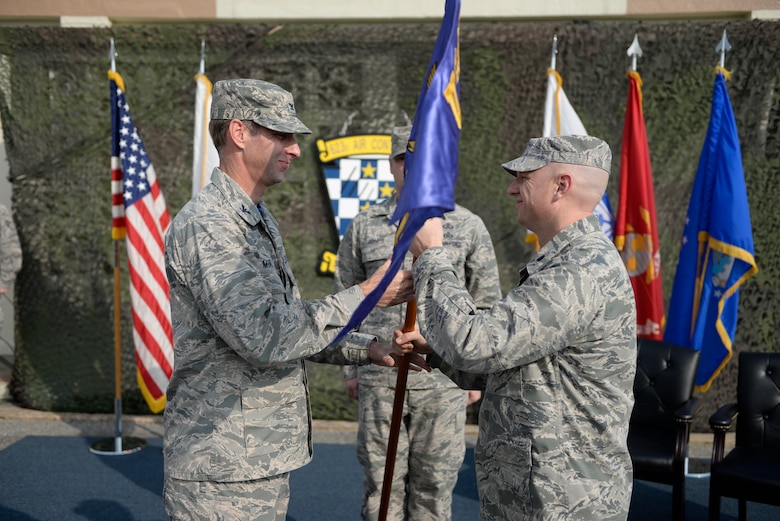 U.S. Air Force Col. David Mineau, 18th Operations Group commander, presents the new 623rd Aircraft Control Squadron guidon to Lt. Col. Daniel Biehl, 623 ACS commander, during a re-designation ceremony April 15, 2016, at Kadena Air Base, Japan. The 623rd Air Control Flight “Lightsword” transitioned back into a squadron for the first time in more than 20 years at 4:23 p.m. (U.S. Air Force photo by Senior Airman Stephen G. Eigel)