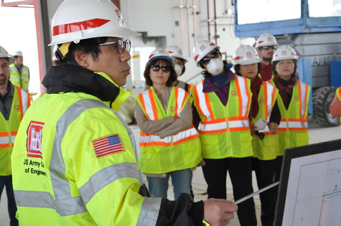 Mr. Pak, Son Yong, Far East District construction surveillance resident office project engineer, briefs district employees on the construction status of the new district motor pool April 12 at Camp Humphreys.