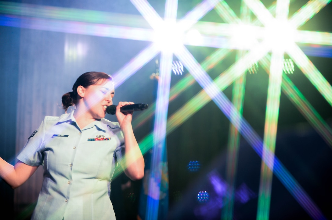 U.S. Air Force Senior Airman Alena Zidlicky, vocalist and French horn player with the United States Heartland of America Band, sings for students during a concert at Aurora Public Schools April 13, 2016 in Aurora Neb. Each of the musicians is a full-time, active-duty member of the Air Force. Their mission is to cultivate positive relationships between the U.S. Air Force and communities across the state through music. (U.S. Air Force photo by Zachary Hada)