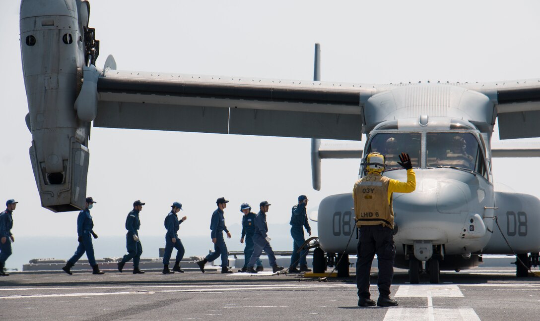 Japan Maritime Self-Defense Force members prepare to load earthquake relief supplies into a U.S. Marine Corps MV-22B Osprey aircraft aboard the JS Hyuga near Kumamoto, April 19, 2016. Navy photo by Petty Officer 3rd Class Gabriel B. Kotico