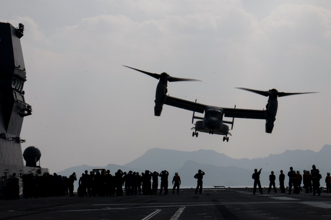 A U.S. Marine Corps MV-22B Osprey aircraft departs from the JS Hyuga after being loaded with supplies to support earthquake relief efforts near Kumamoto, Japan, April 19, 2016. Navy photo by Petty Officer 3rd Class Gabriel B. Kotico