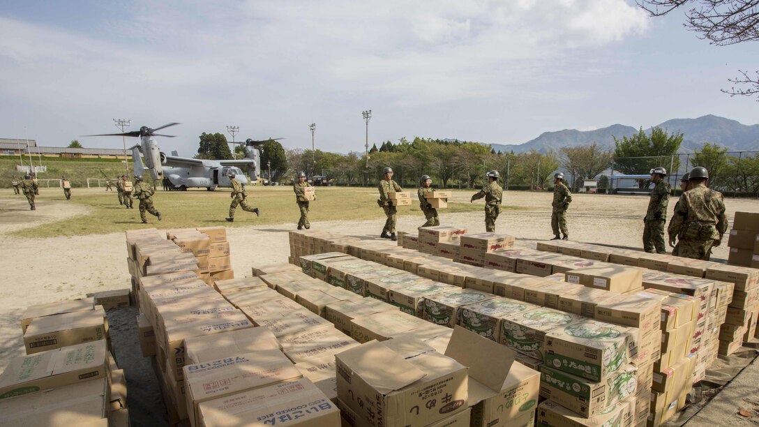 Japan Ground Self Defense Force personnel carry supplies from a U.S. Marine Corps MV-22B Osprey tiltrotor aircraft from Marine Medium Tiltrotor Squadron 265, 31st Marine Expeditionary Unit, in Hakusui Sports Park, Kyushu island, Japan, April 20, 2016. The supplies are in support of the relief effort after a series of earthquakes struck the island of Kyushu. The 31st MEU is the only continually forward-deployed MEU and remains the Marine Corps' force-in-readiness in the Asia-Pacific region.