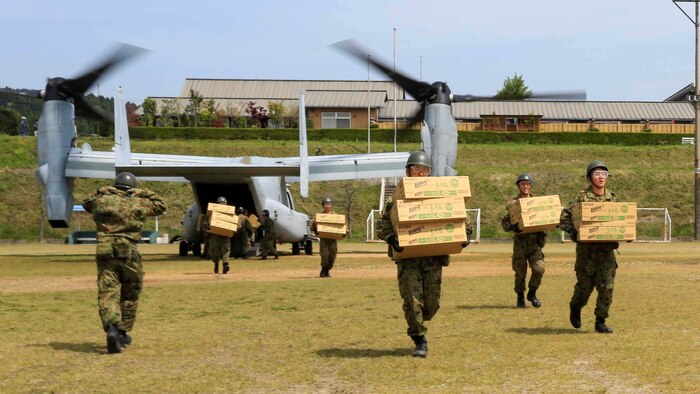 Japan Ground Self Defense Force personnel carry supplies from a U.S. Marine Corps MV-22B Osprey tiltrotor aircraft from Marine Medium Tiltrotor Squadron 265, 31st Marine Expeditionary Unit, in Hakusui Sports Park, Kyushu island, Japan, April 20, 2016. The supplies are in support of the relief effort after a series of earthquakes struck the island of Kyushu. The 31st MEU is the only continually forward-deployed MEU and remains the Marine Corps' force-in-readiness in the Asia-Pacific region. 