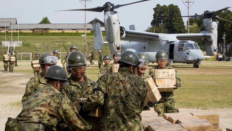 Japan Ground Self Defense Force personnel carry supplies from a U.S. Marine Corps MV-22B Osprey tiltrotor aircraft from Marine Medium Tiltrotor Squadron 265, 31st Marine Expeditionary Unit, in Hakusui Sports Park, Kyushu island, Japan, April 20, 2016. The supplies are in support of the relief effort after a series of earthquakes struck the island of Kyushu. The 31st MEU is the only continually forward-deployed MEU and remains the Marine Corps' force-in-readiness in the Asia-Pacific region.