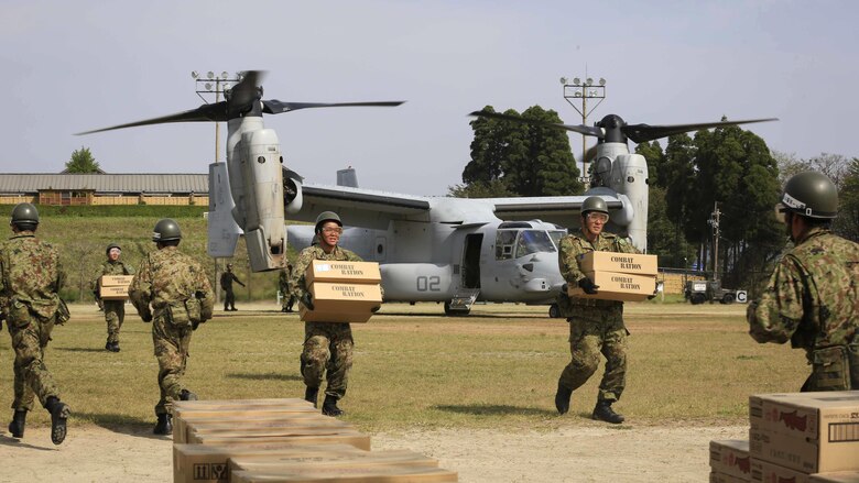 Japan Ground Self Defense Force personnel carry supplies from a U.S. Marine Corps MV-22B Osprey tiltrotor aircraft from Marine Medium Tiltrotor Squadron 265, 31st Marine Expeditionary Unit, in Hakusui Sports Park, Kyushu island, Japan, April 20, 2016. The supplies are in support of the relief effort after a series of earthquakes struck the island of Kyushu. The 31st MEU is the only continually forward-deployed MEU and remains the Marine Corps' force-in-readiness in the Asia-Pacific region. 