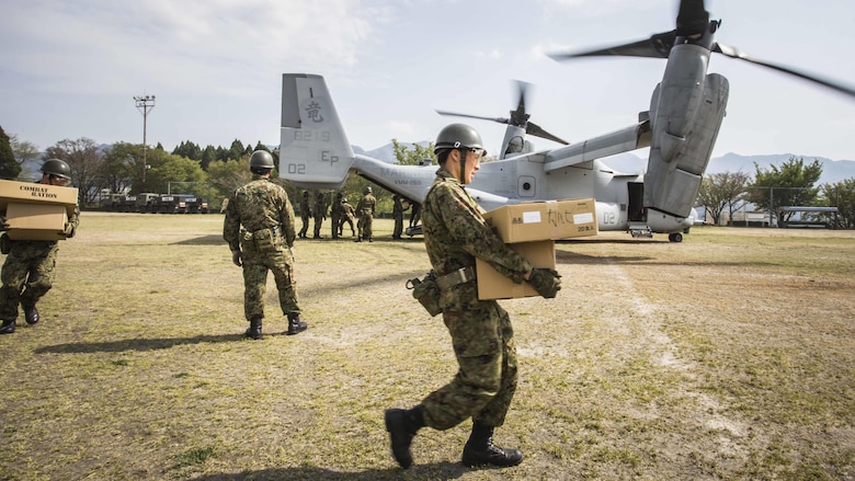 Japan Ground Self Defense Force personnel carry supplies from a U.S. Marine Corps MV-22B Osprey tiltrotor aircraft from Marine Medium Tiltrotor Squadron 265, 31st Marine Expeditionary Unit, in Hakusui Sports Park, Kyushu island, Japan, April 20, 2016. The supplies are in support of the relief effort after a series of earthquakes struck the island of Kyushu. The 31st MEU is the only continually forward-deployed MEU and remains the Marine Corps' force-in-readiness in the Asia-Pacific region.