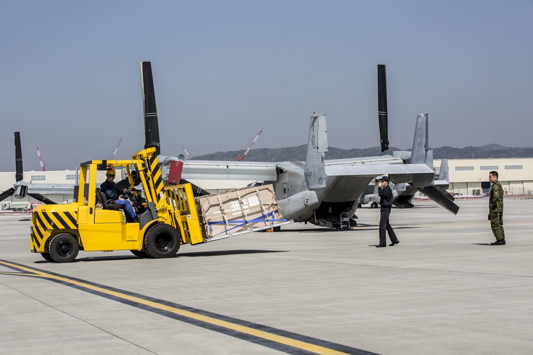 A Japanese service member operates a forklift to move a pallet of supplies for loading into a U.S. Marine Corps MV-22B Osprey aircraft at Marine Corps Air Station Iwakuni, Japan, April 20, 2016. Marine Corps photo by Cpl. Nathan Wicks