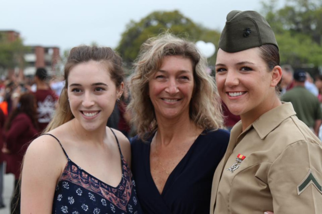 Marine Corps Pfc. Dayle M. Taber, embraces her mom and sister after her graduation ceremony at Marine Corps Recruit Depot Parris Island, S.C., April 1, 2016. Courtesy photo