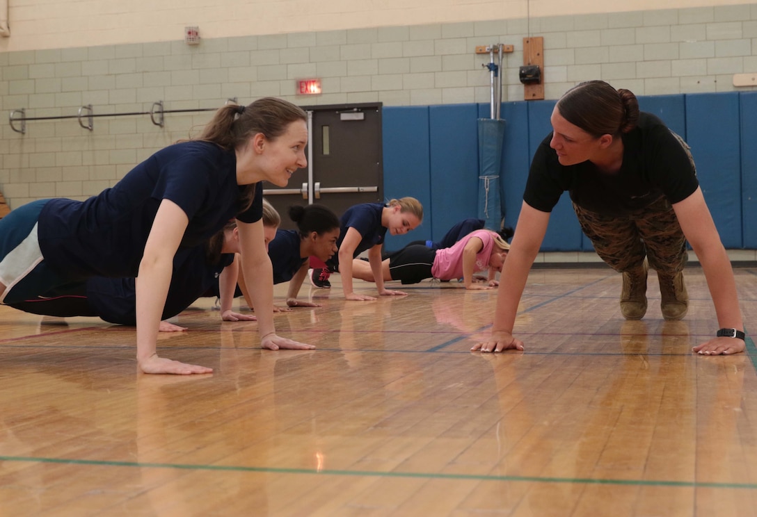 Marine Corps Pfc. Dayle M. Taber, a recent recruit training graduate, teaches push-up techniques to female Delayed Entry Program enlistees during an all-female pool function in Rochester, N.Y., April 9, 2016. Taber also shared her boot camp experiences with the future female Marines during the function. Marine Corps photo by Staff Sgt. Christopher O’Quin